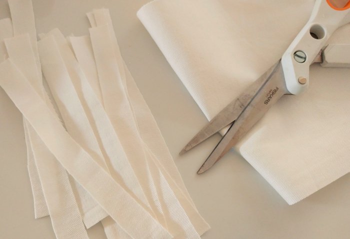 cutting white fabric strips