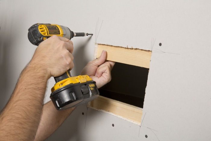 repairing a drywall hole
