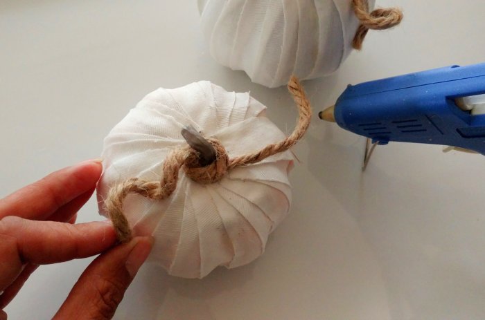 adding twine stem to decorative fabric pumpkin