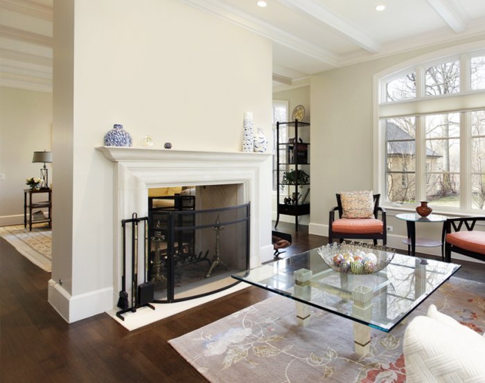 White fireplace mantel with black fire screen