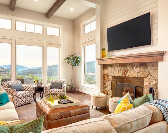 TV mounted above wood and stone fireplace mantel