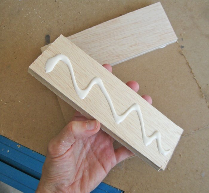 hand holding wood with glue