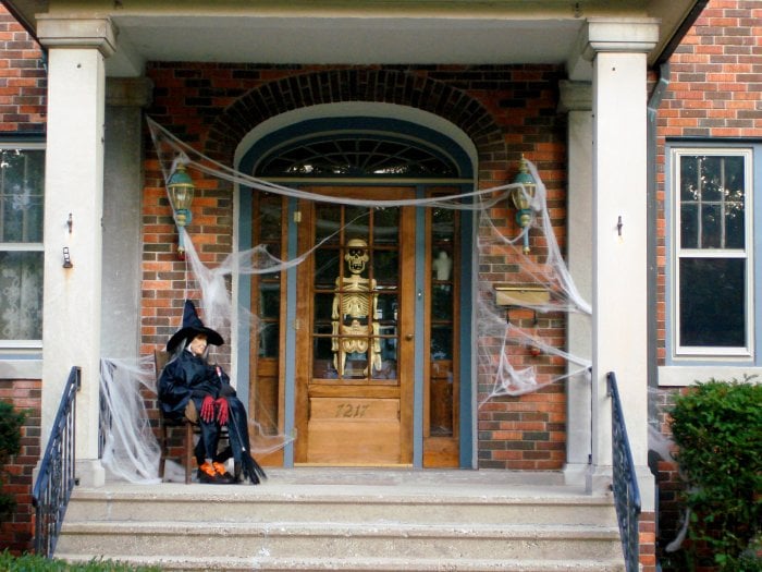 Halloween porch with cobwebs, skeleton and witch