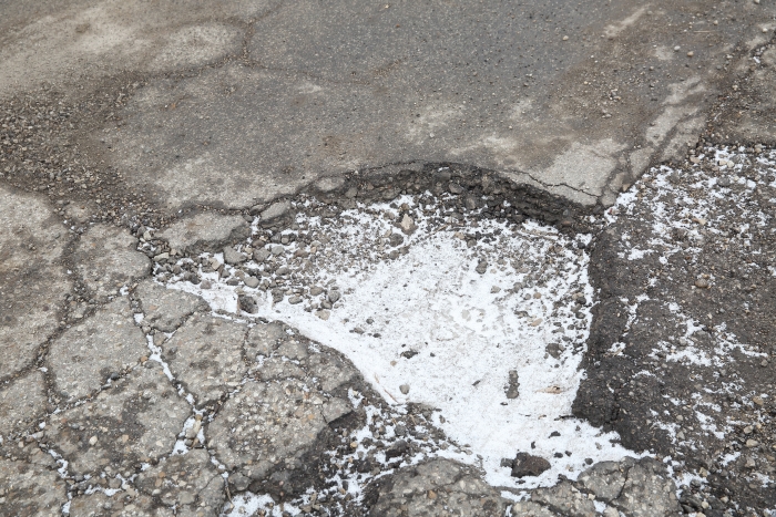 To increase your chances for reimbursement for pothole damage, immediately report the pothole location to city officials, as well as the damage it caused. (Photo by Steve C. Mitchell)