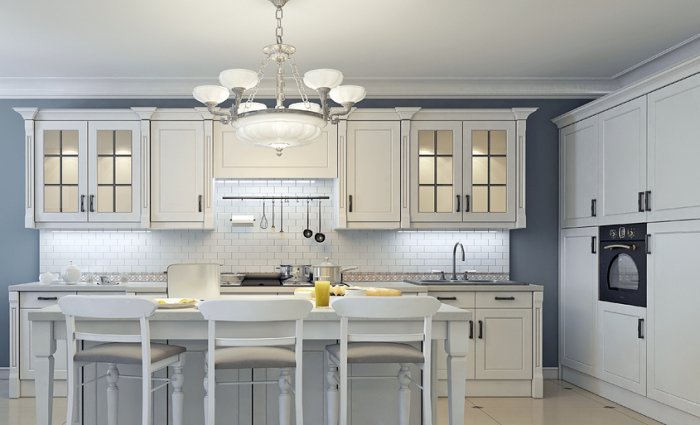 white and gray kitchen with chandelier and under cabinet lighting