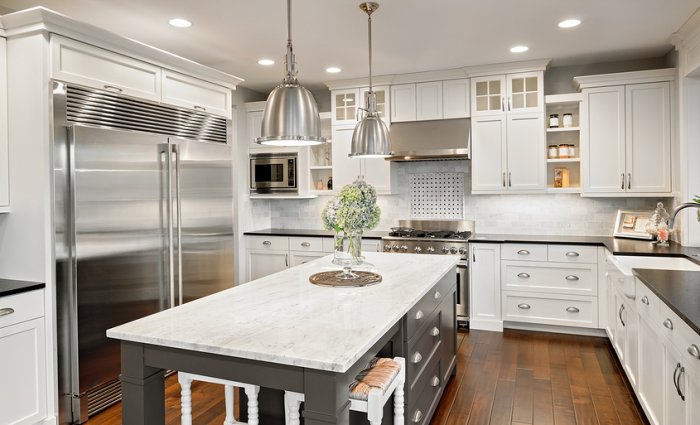 white and gray kitchen island with chrome pendant lights