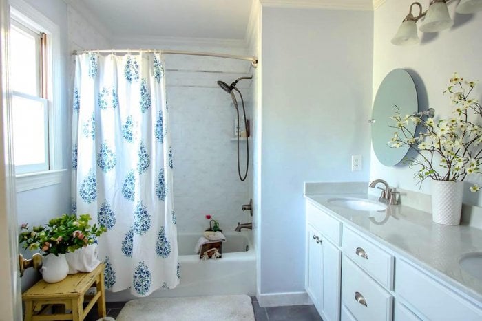 master bathroom with curved shower curtain