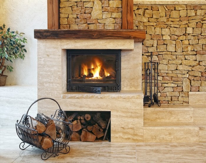 combination marble and stone fireplace with firewood holder