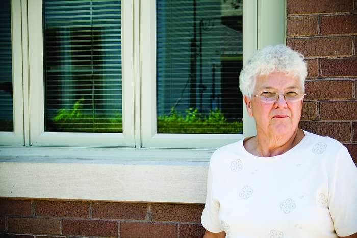 Sue Hudelson in front of her Greek Revival Irvington home
