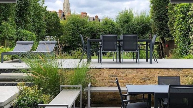 Backyard patio with outdoor kitchen table and chairs