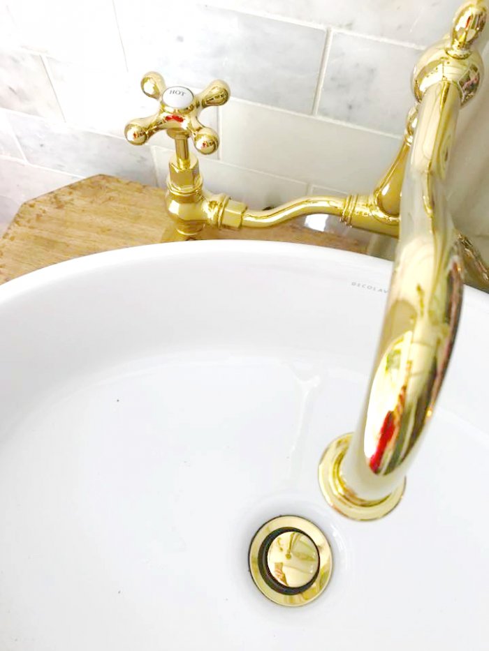 Install a new decorative faucet to add to the charm of the bathroom. (Photo courtesy of Courtney A/The French Country Cottage)