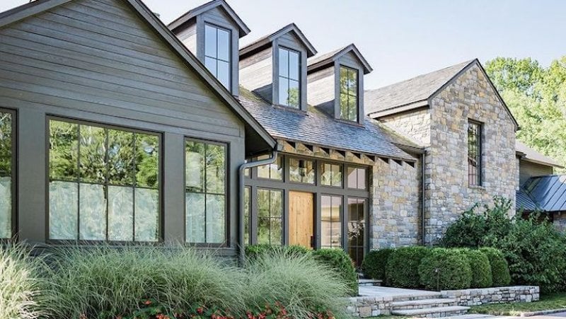 Exterior of home with stone and large windows