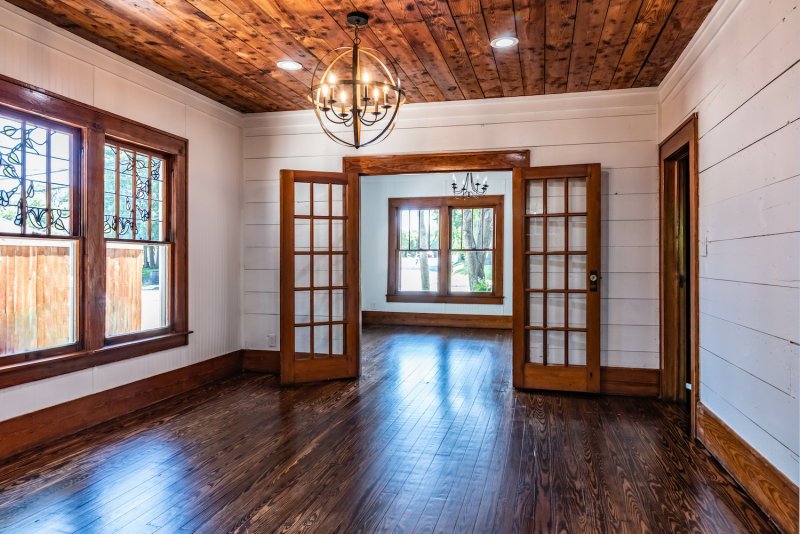 Craftsman-style living room with shiplap walls, original shiplap ceiling, and hardwood floors (Photo by AdrieDee - stock.adobe.com)