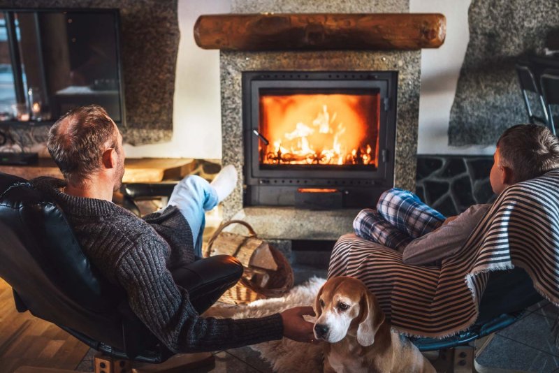 Father with son sitting near fireplace (Photo by Soloviova Liudmyla - stock.adobe.com)