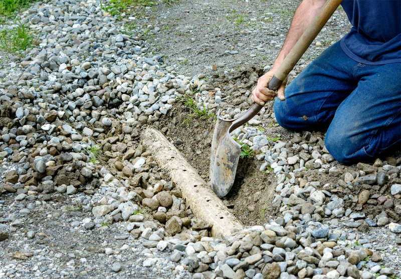 Person installing a French drain (Photo by KQ Ferris - stock.adobe.com)