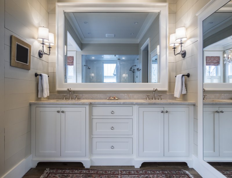 Bathroom vanity with two sinks, marble countertops and a large mirror surrounded by shiplap walls (Photo by Wollwerth Imagery - stock.adobe.com)