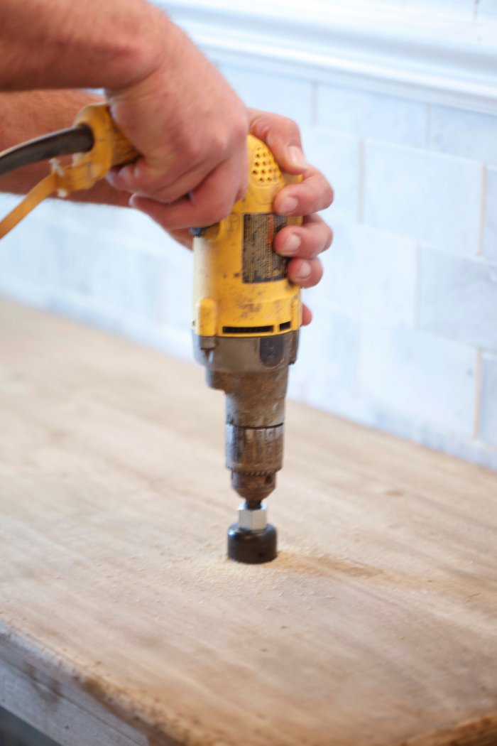 Cut the holes in the console to fit the pipes. (Photo courtesy of Courtney A/The French Country Cottage)
