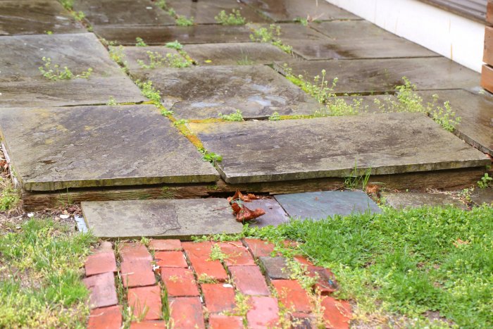The bluestone patio was uneven and the base was rotting, making it dangerous. (Photo courtesy of Melissa Caughey/Tilly's Nest)