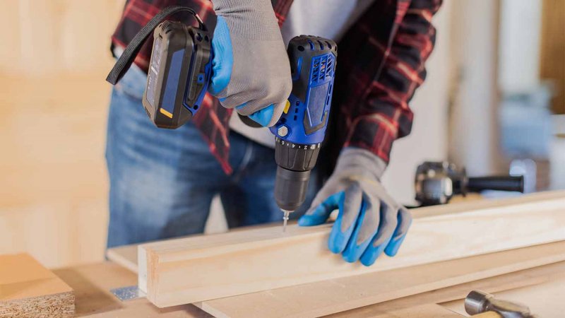 handyman using electric drill (Photo by JJavier Pardina/Stocksy - stock.adobe.com)
