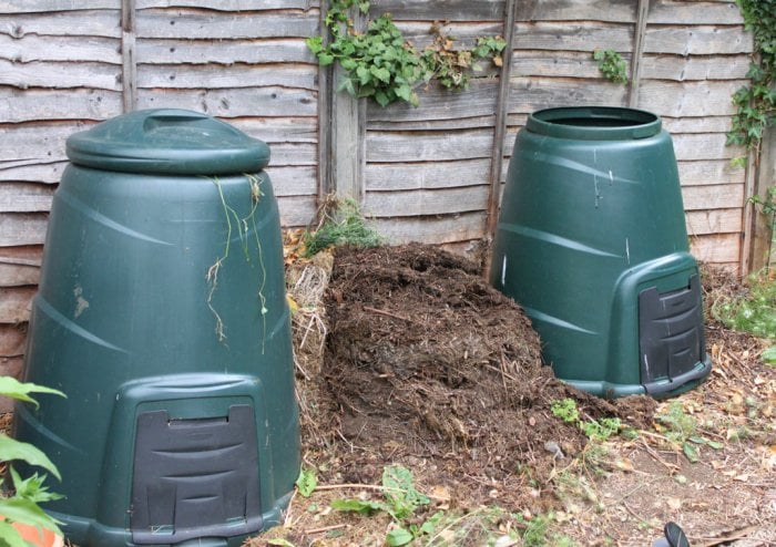 Compost bins and pile in a backyard