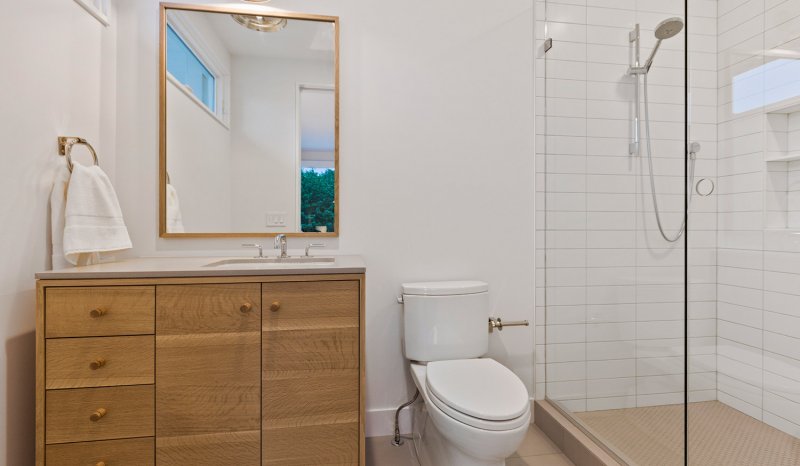 Modern bathroom with wood cabinets (Photo by PC Photography/iStock/Getty Images Plus via Getty Images)
