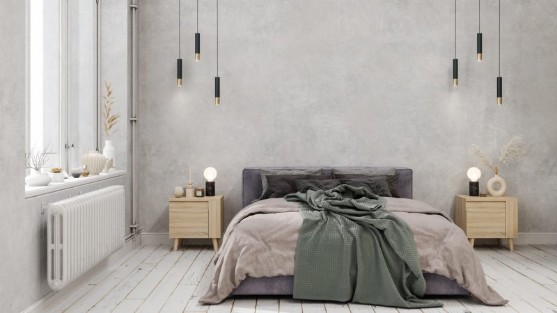 A bedroom with pendant lights and gray walls (Photo by onurdongel/E+ via Getty Images)