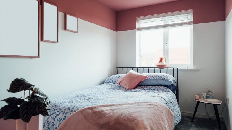 A bedroom with white walls and pink ceiling (Photo by SolStock/E+ via Getty Images)