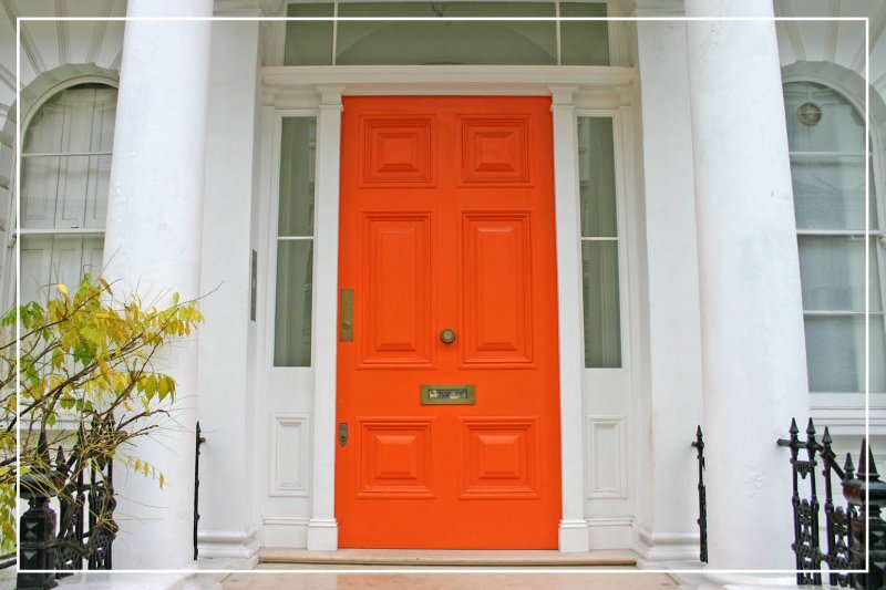 bright orange front door (Photo by CvE/iStock/Getty Images Plus via Getty Images)