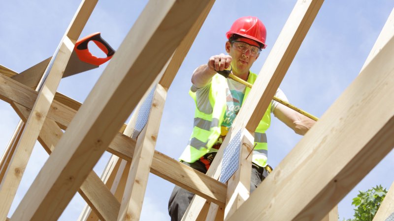 A builder working on the roof of a house (Photo by Peter Cade/Stone via Getty Images)