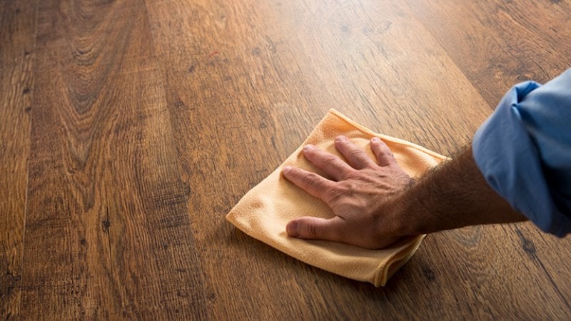 Cleaning hardwood with cloth (Photo by stokkete - stock.adobe.com)