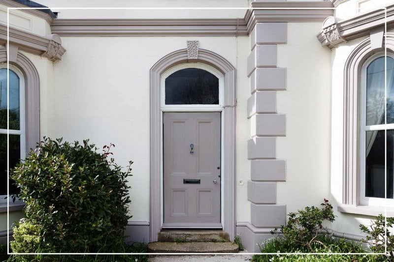 cobblestone gray front door (Photo by nicolamargaret/iStock/Getty Images Plus via Getty Images)