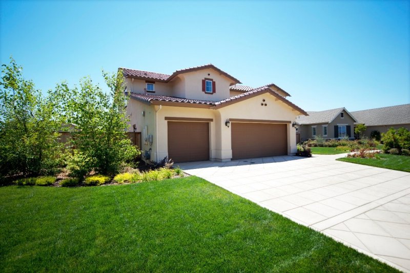 concrete driveway in front of suburban home