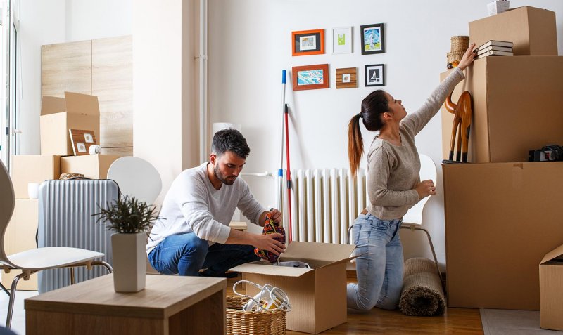 Couple unpacks moving boxes at new home (Photo by BalanceFormCreative - stock.adobe.com)
