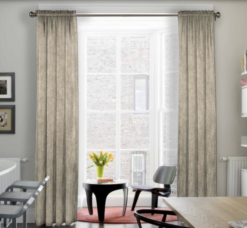 beige drapery curtains in window