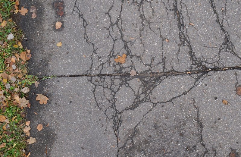 cracks in driveway (Photo by banksy_boy/Shutterstock.com)