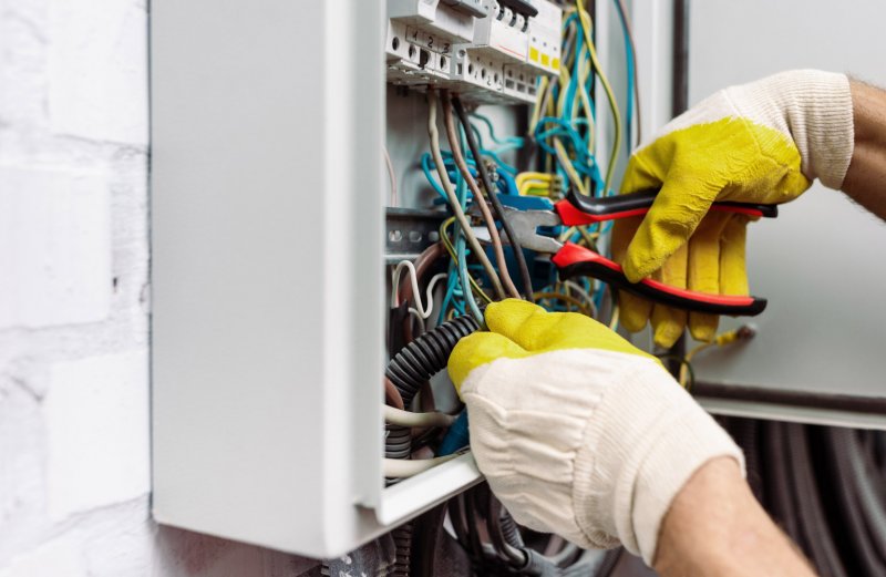 fixing electrical wires (Photo by LightField Studios/Shutterstock.com)