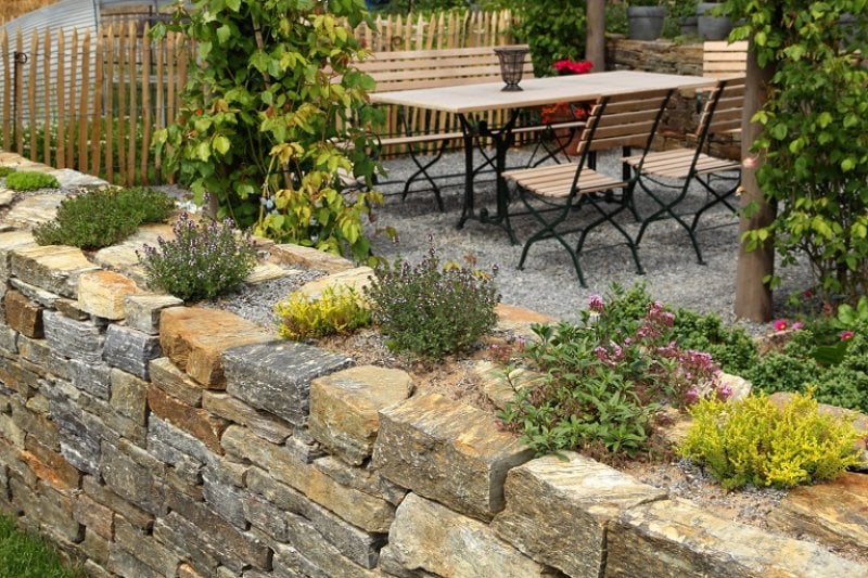 Stone wall with plants (Photo by BasieB / iStock / Getty Images Plus via Getty Images)