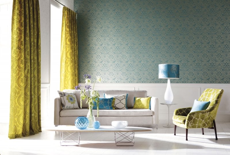 Blue patterned wallpaper and wainscoting accent wall in living room (Photo by Onzeg /E+ via Getty Images)