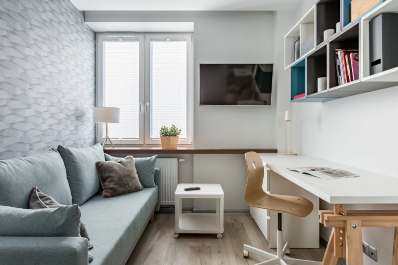 Home office with light wallpaper accent wall (Photo by Dariusz Jarzabek - stock.adobe.com)