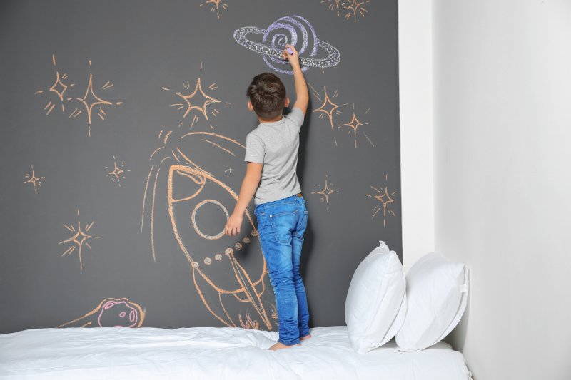 Chalkboard paint accent wall kids room (Photo by New Africa - stock.adobe.com)