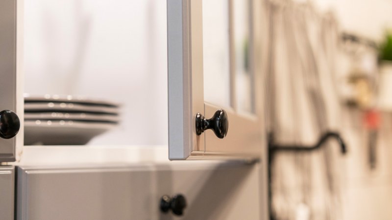 A kitchen cabinet slightly open (Photo by yipengge/iStock / Getty Images Plus via Getty Images)