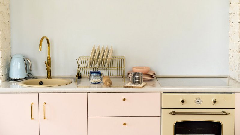 A minimalistic kitchen with sink, stove and work surface (Photo by Fiordaliso/Moment via Getty Images)