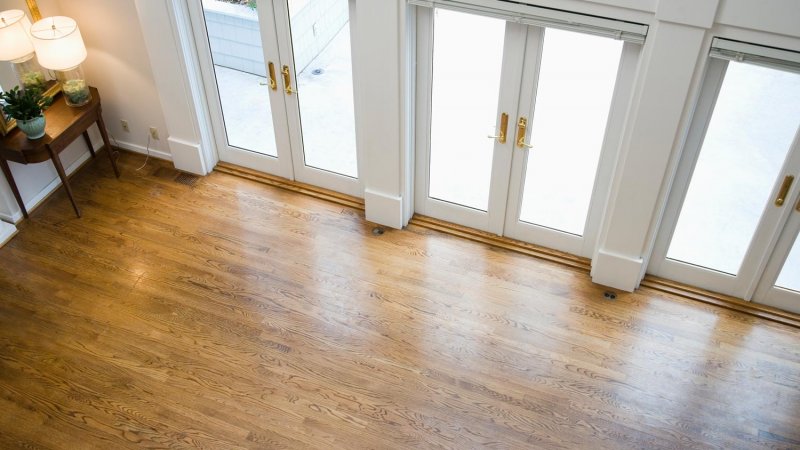 An empty living room with laminate flooring (Photo by Mint Images/Mint Images RF via Getty Images)