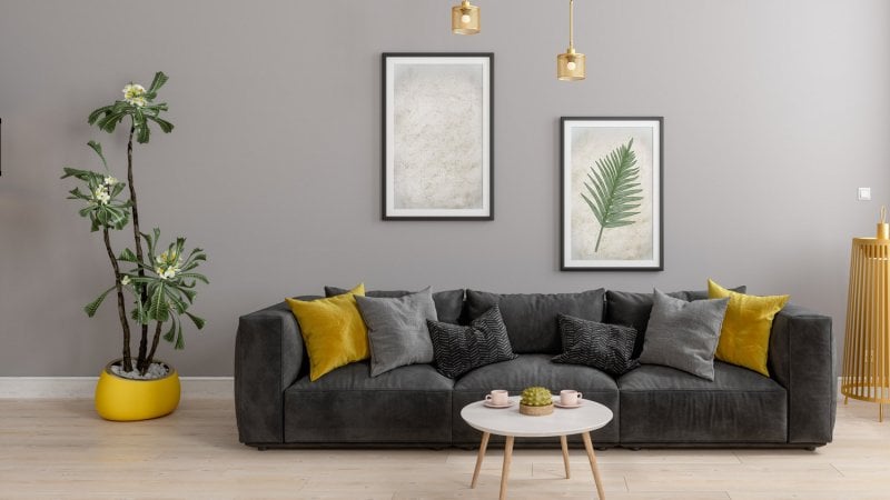 A living room with a gray wall and a gray sofa (Photo by onurdongel/iStock / Getty Images Plus via Getty Images)