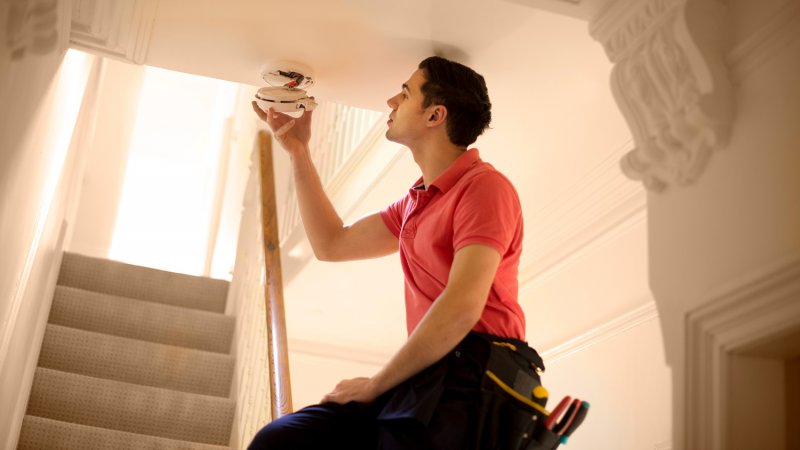 Man inspects the smoke detector is working properly (Photo by sturti/iStock/Getty Images Plus via Getty Images)
