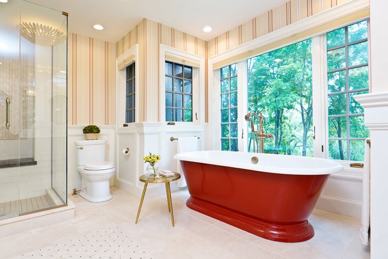 Contemporary bathroom with freestanding red bathtub Contemporary bathroom with freestanding red bathtub (Photo by YinYang/E+/Getty Images)