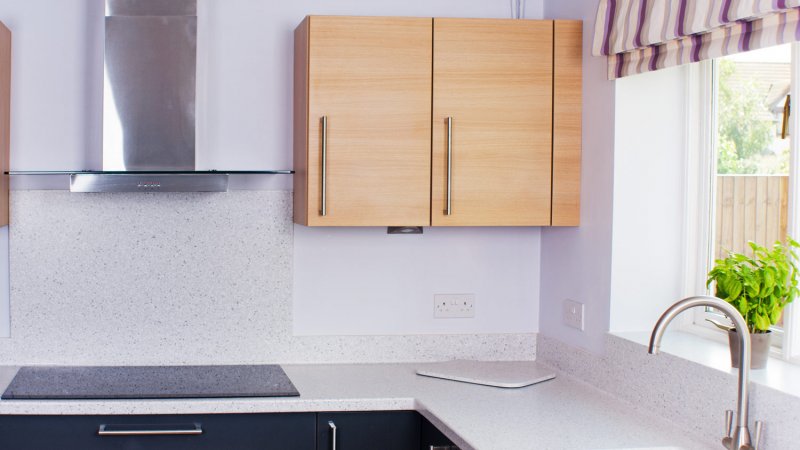 A modern kitchen with grey cupboards, oak cabinets and laminate countertop (Photo by Alphotographic/E+ via Getty Images)