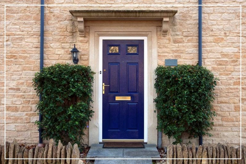 navy blue front door (Photo by ChrisAt/iStock/Getty Images Plus via Getty Images)