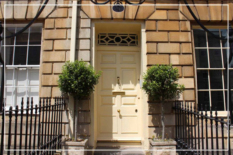 off-white painted front door (Photo by mtreasure/iStock/Getty Images Plus via Getty Images)