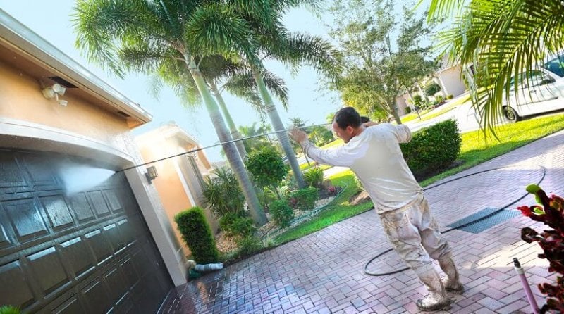 professional power washes a fancy California home (Photo by Jodi Jacobson / E+ / Getty Images)